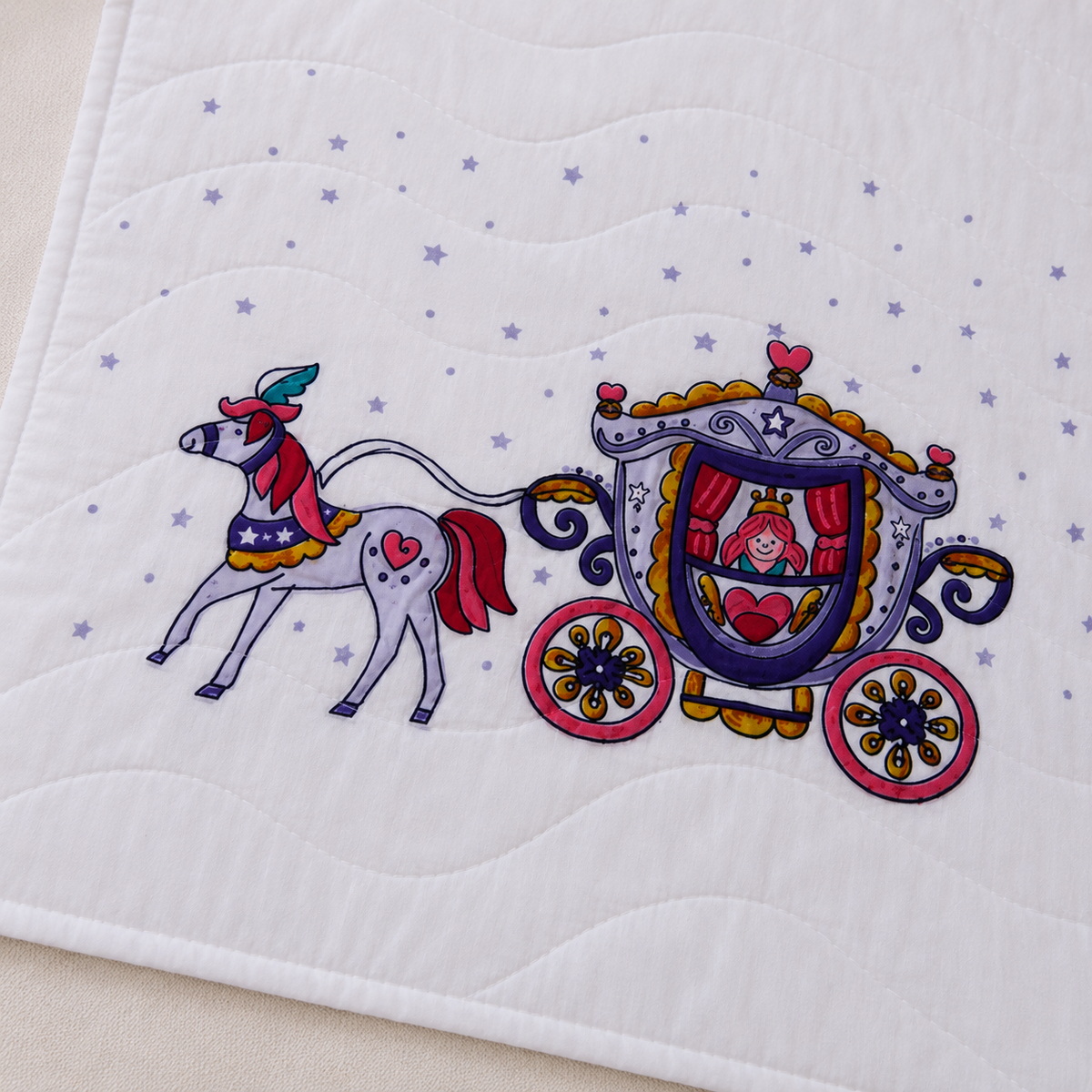 Close up of Royal Carriage Baby Blanket showing detailed princess carriage embroidery with horse hearts and gold scrollwork