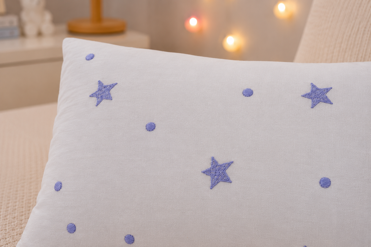 Starry Night Baby Pillow close up showing lavender tufted star texture on white cotton
