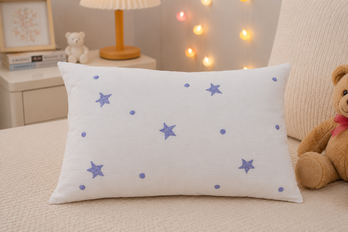 Starry Night Baby Pillow in white cotton with scattered lavender tufted star and dot appliqués
